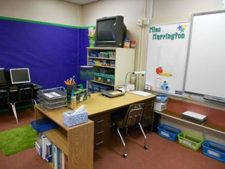 A close up of Tessa's desk, notice how the chair faces the wall, and will swivel to teach the class.